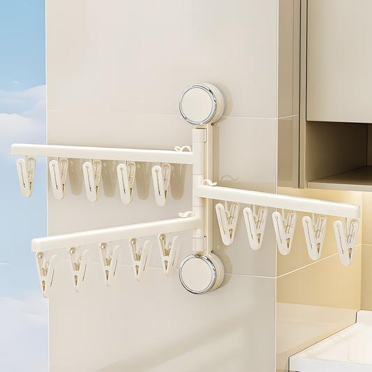 Foldable wall-mounted clothes rack with strong suction cups, saving space.